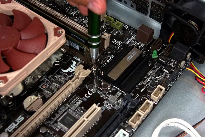 Screwing in Motherboard